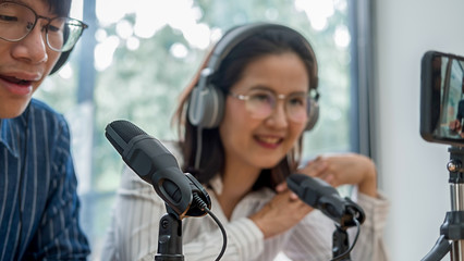 Young business people recording a podcast in a studio