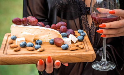 Set of elite delicious food, Brie cheese, grape, migdal and blueberry