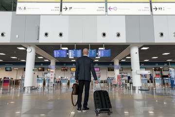 Unrecognizable executive waiting for departure in airport terminal