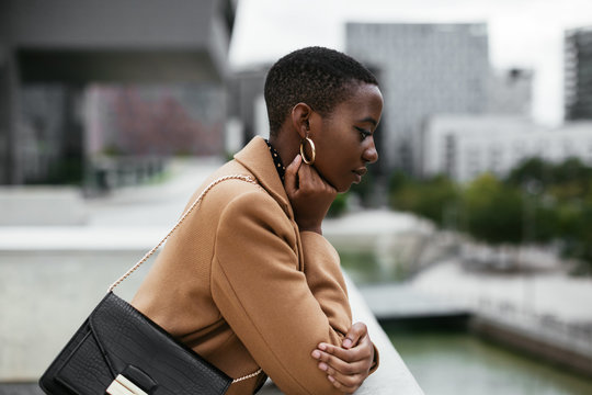 Dreamy black lady looking at water