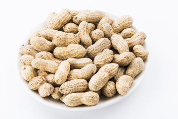 Close-up of delicious peanuts on a white dish