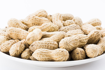Close-up of delicious peanuts on a white dish