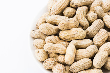 Close-up of delicious peanuts on a white dish
