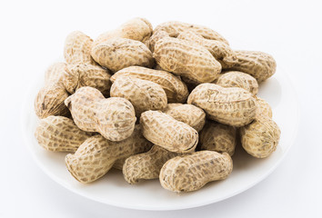 Close-up of delicious peanuts on a white dish
