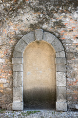 Closed door with arch. Bricked up door in an ancient wall