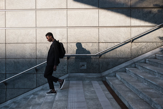 Young businessman walking in the city