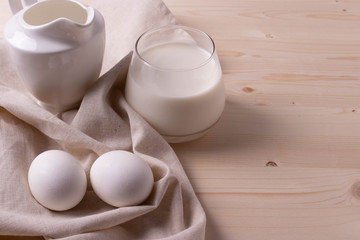 two white eggs and milk as calcium concept. minimalism style.