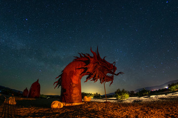Milky way night photography with dragon metal sculpture taken in the desert of Borrego Springs California