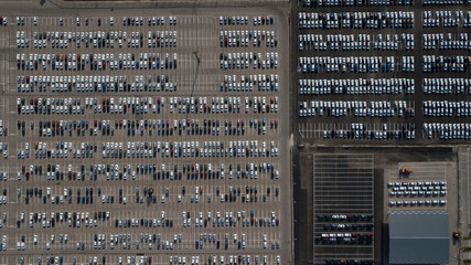 Large car parking in front of a car factory - grid filled with cars