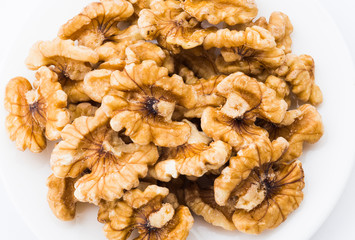 Close-up of delicious walnuts on a white dish