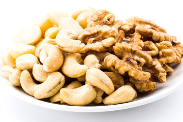 Variety of fresh nuts on the white background