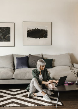Stylish freelancer using laptop at home