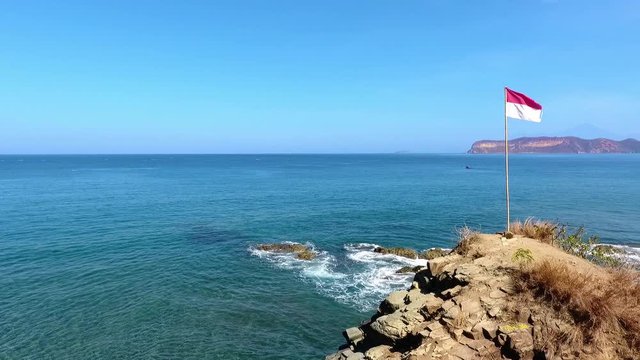 Aerial point of interest view of the Poto Batu Beach in Indonesia. National flag.