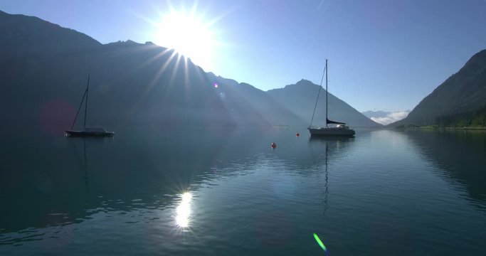 Establishing shot, Scenic view, boats on Achensee lake, bright sunny day reflecting.