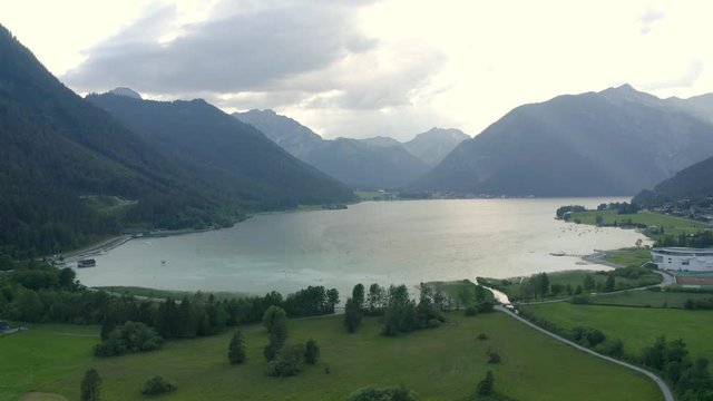 Aerial view approaching shot, scenic view of Lake Achen (Achensee) in Austria, mountain range and blue sky in the background.