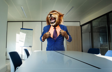 Angry boss concept with lion in the suit stand and tear shirt using paws near desk roaring