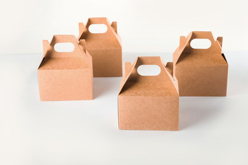 Cardboard boxes on a white background. Ecological packaging of paper products close-up and copy space. Craft containers, packaging, boxes, packages.
