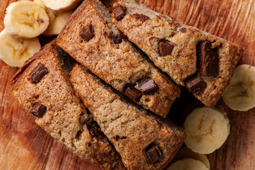 .Rustic homemade cake made from babana with pieces of chocolate.