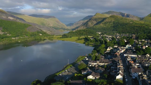 Sprawling Lush Green Landscape And A Provincial Village in Snowdonia Wales UK - aerial shot of Llanberis