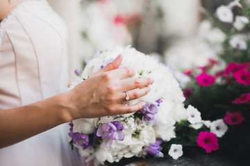 Bride holding big and beautiful wedding bouquet with flowers