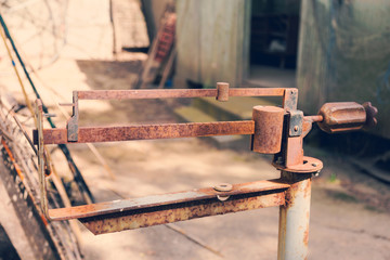 Ancient platform scales; wood and iron weighing machine. Selective focus. Tinted photograph.