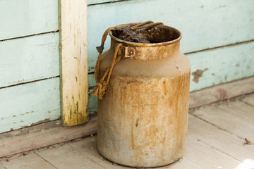Big old metal jar. Selective focus. Tinted photo.