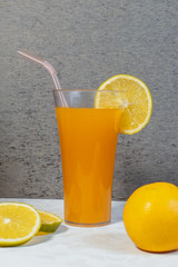 glass of orange juice and orange
