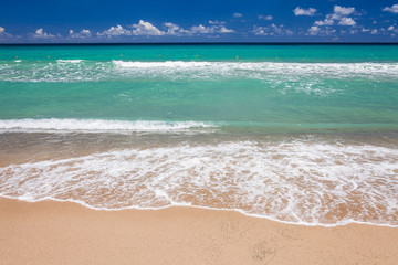 Ocean waves, beach, and blue sky in the Kenting National Park of Pingtung, Taiwan.