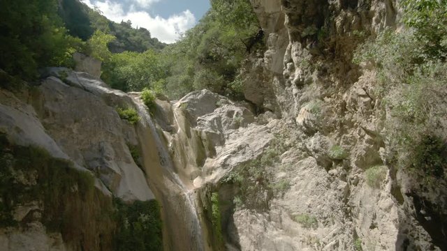 Circling drone shot of Dimosari Waterfall  in Lefkada