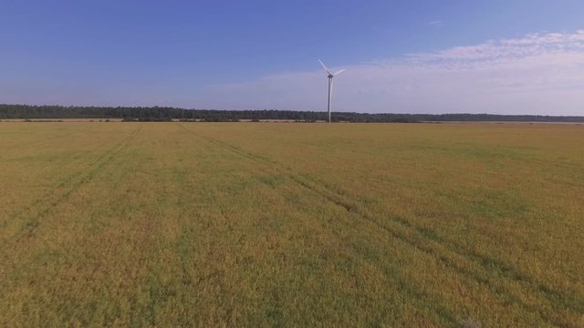 Wind Farm Turbine On A Sunny Summer Day. Aerial Dolly-In Pedestal-Up Shot