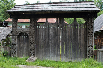 Traditional carved ancient wooden gate. Maramures, Romania.