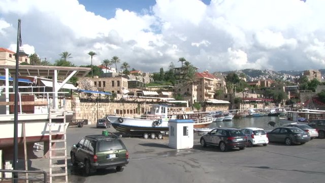 Old Byblos Fishing port, Fishing boats and ships, parked cars, people walking, Byblos, Lebanon