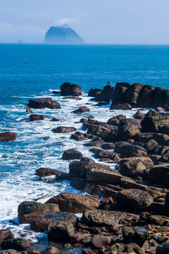The beautiful coastal reef and sea waves with blue sky in New Taipei, Taiwan