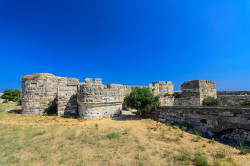 Fototapeta na wymiar Neratzia Castle,Sculpture-strewn, 14th-century ruins of a seaside fortress featuring panoramic vistas of Kos harbor.Kos, Greece