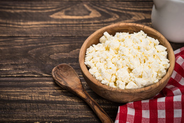 Curd or cottage cheese at wooden table.