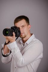Fototapeta premium Young man using a professional camera