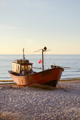 Fototapeta premium fisherman boats at sunrise time on the beach