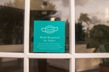 Must wear your mask to enter indoor businesses mandate stock photo 