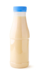 Condensed milk in a plastic bottle on a white background. Isolated
