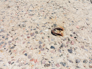 Reinforced concrete surface is covered with cracks, scratches, inclusions of granite and rusty metal bars. You can use as the background for any of your project.