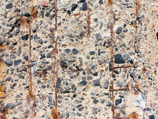 Reinforced concrete surface is covered with cracks, scratches, inclusions of granite and rusty metal bars. You can use as the background for any of your project.