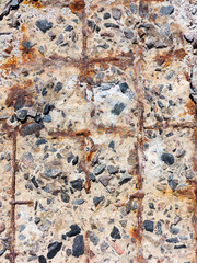 Reinforced concrete surface is covered with cracks, scratches, inclusions of granite and rusty metal bars. You can use as the background for any of your project.