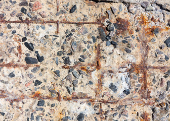 Reinforced concrete surface is covered with cracks, scratches, inclusions of granite and rusty metal bars. You can use as the background for any of your project.