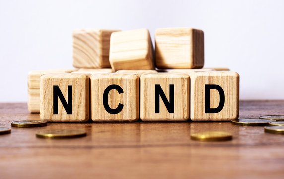 wooden cubes and NCND, coins, the concept of taxation, increase taxes and fees