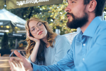 Man and woman communicate in the park outdoors in blue shirts employees friends work