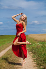 portrait of a young beautiful blonde woman in red dress