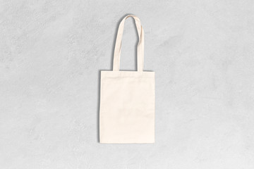 Shopping canvas or cotton bag on grey concrete background. Mock-up for branding. 