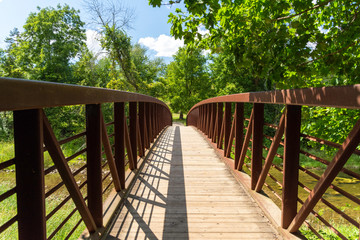 Fototapeta na wymiar wood and steel bridge over the river at Ball's Falls, Niagara Region, Ontario.