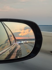 travel rearview mirror leaving vacation bridge driving road cars