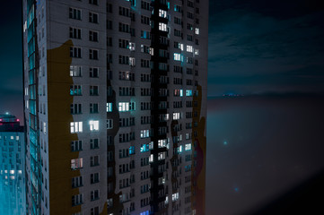 Fototapeta na wymiar night fog in the city in the middle of high-rise buildings